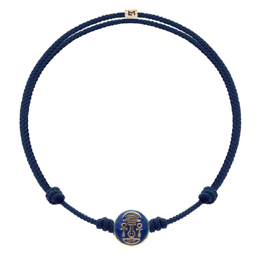 LUIS MORAIS 14K yellow gold small disk with a blue enameled Good Luck symbol disk on an adjustable cord bracelet.  