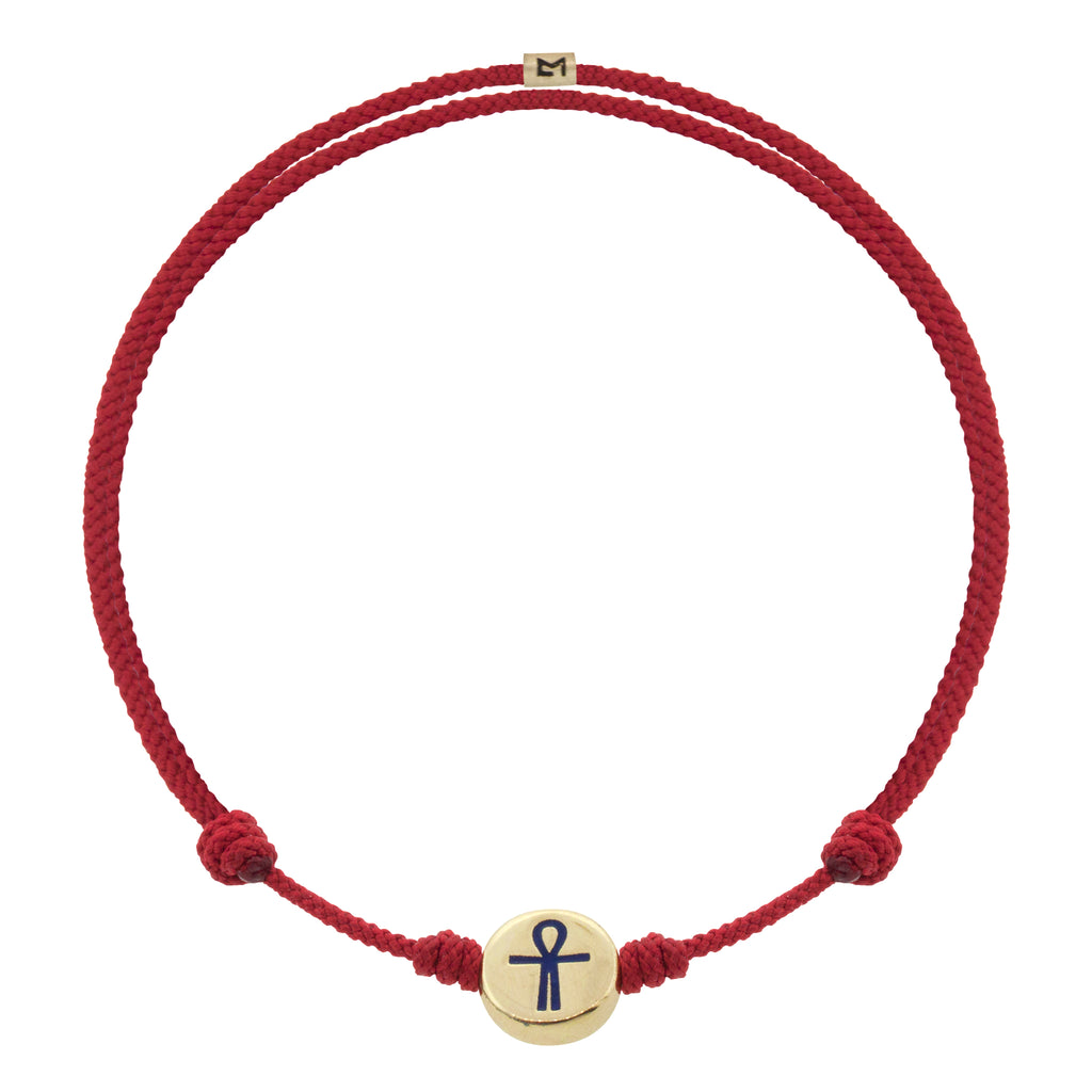 LUIS MORAIS 14K yellow gold small disk with a blue enameled Ankh symbol on an adjustable cord bracelet. Features a 14K gold logo spacer.