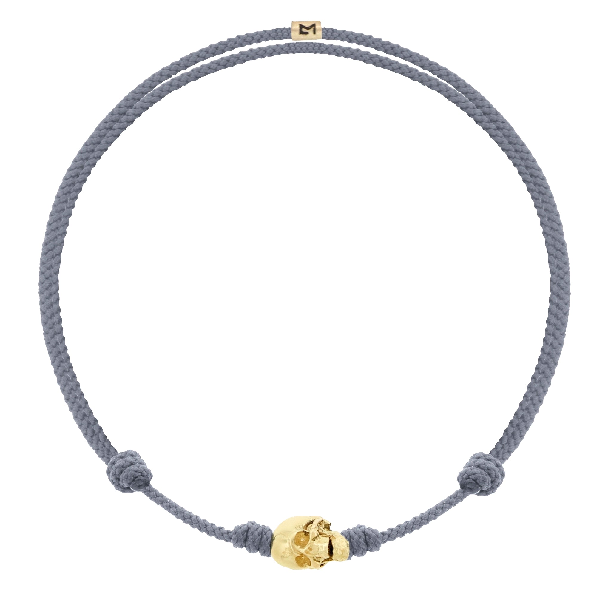 LUIS MORAIS 14k yellow G6 gold skull with moving jaw on an adjustable cord bracelet.