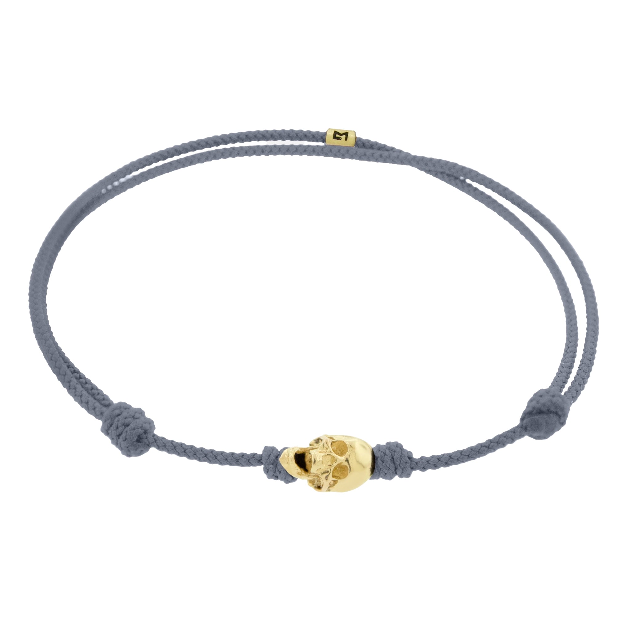 LUIS MORAIS 14k yellow G6 gold skull with moving jaw on an adjustable cord bracelet.
