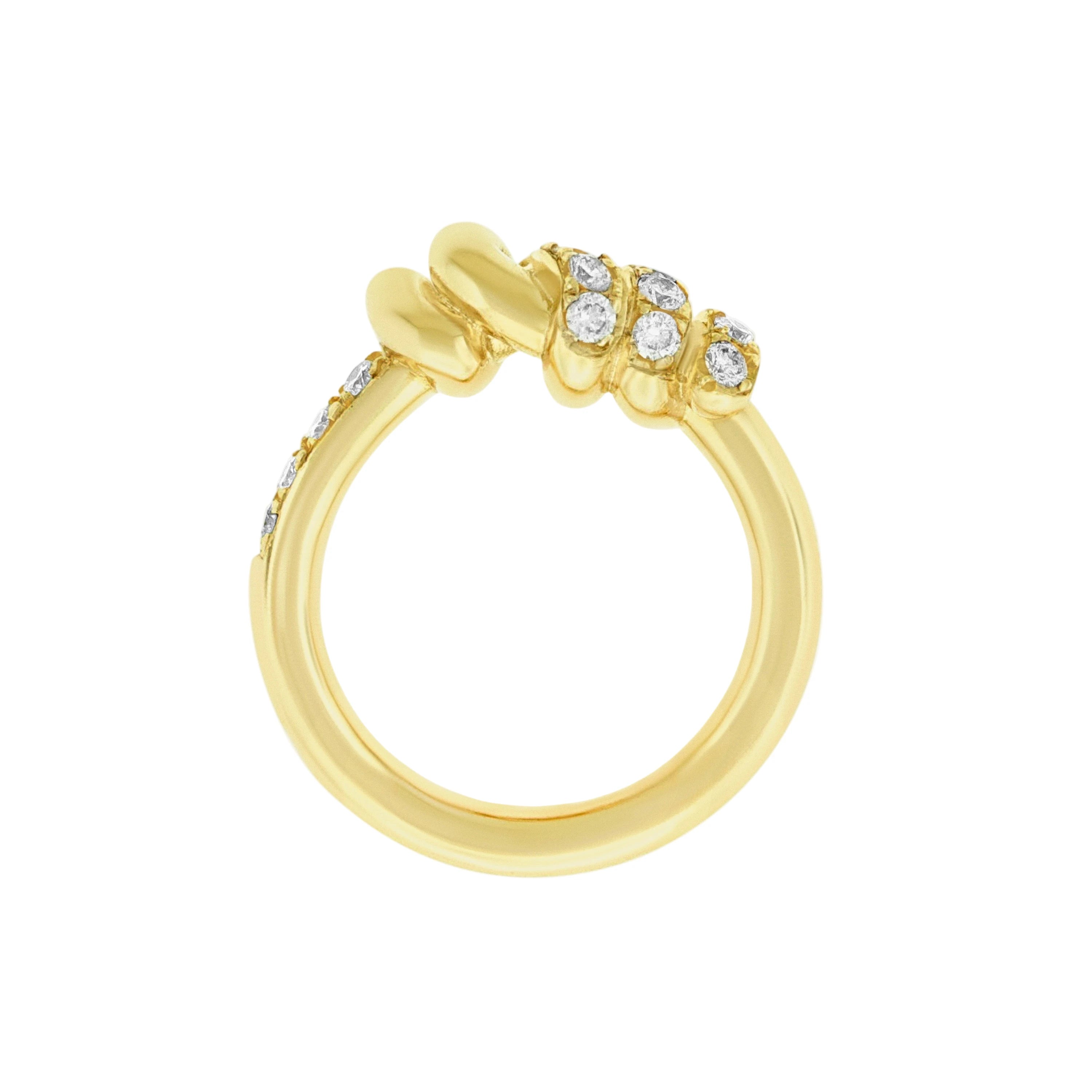 Gold ring with diamond accents on a white background