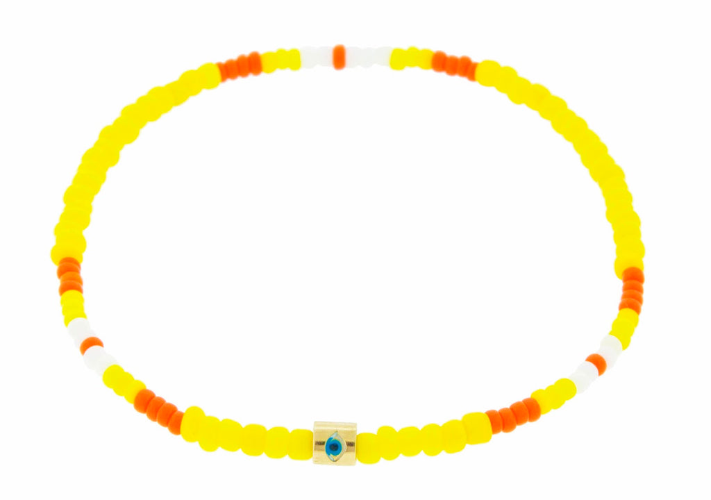 LUIS MORAIS 14K yellow gold short roll with enameled Eye symbol on a yellow tribal pattern glass beaded bracelet.