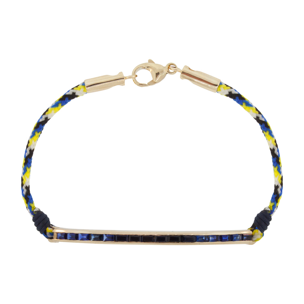 LUIS MORAIS 14K gold large link ID bar with sapphires baguettes and extra-long 14k yellow gold lobster clasp closure on a cord bracelet.