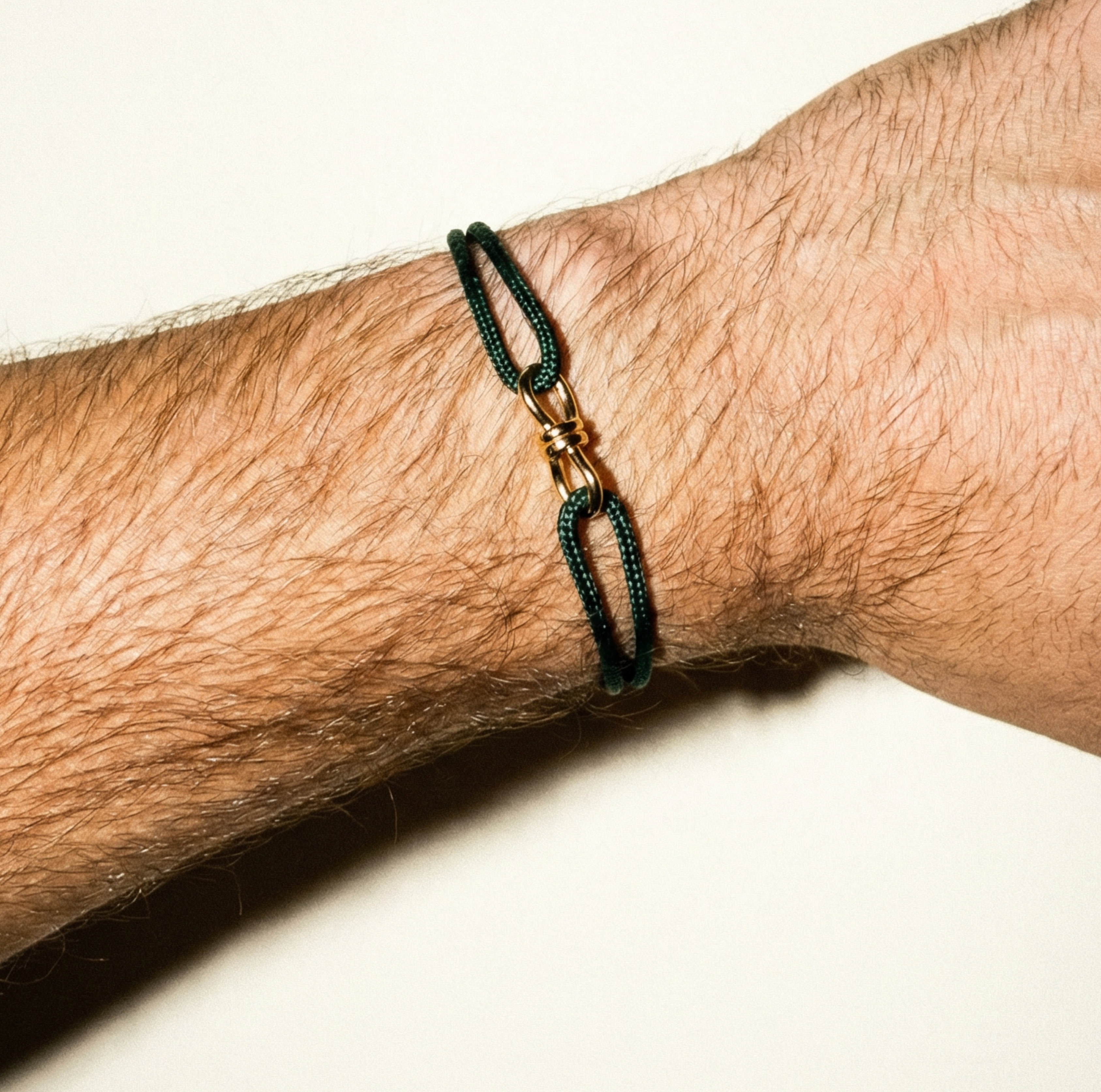 LUIS MORAIS 14k yellow gold large twisted wire knot on a thick cord bracelet. 