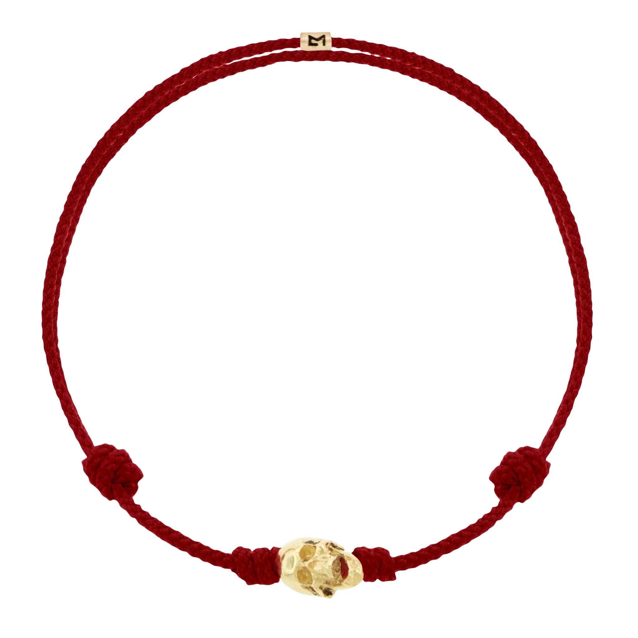 LUIS MORAIS 14k yellow G6 gold skull with moving jaw on an adjustable cord bracelet.