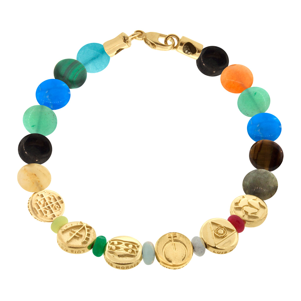 LUIS MORAIS six 14K yellow gold small disks with symbols on a multi gemstone disk beaded bracelet with a 14K yellow gold long clasp. The symbols include the ancient money seal, moor protection symbol, triple Horus eyes, Naja protection symbol and a scarab symbol.