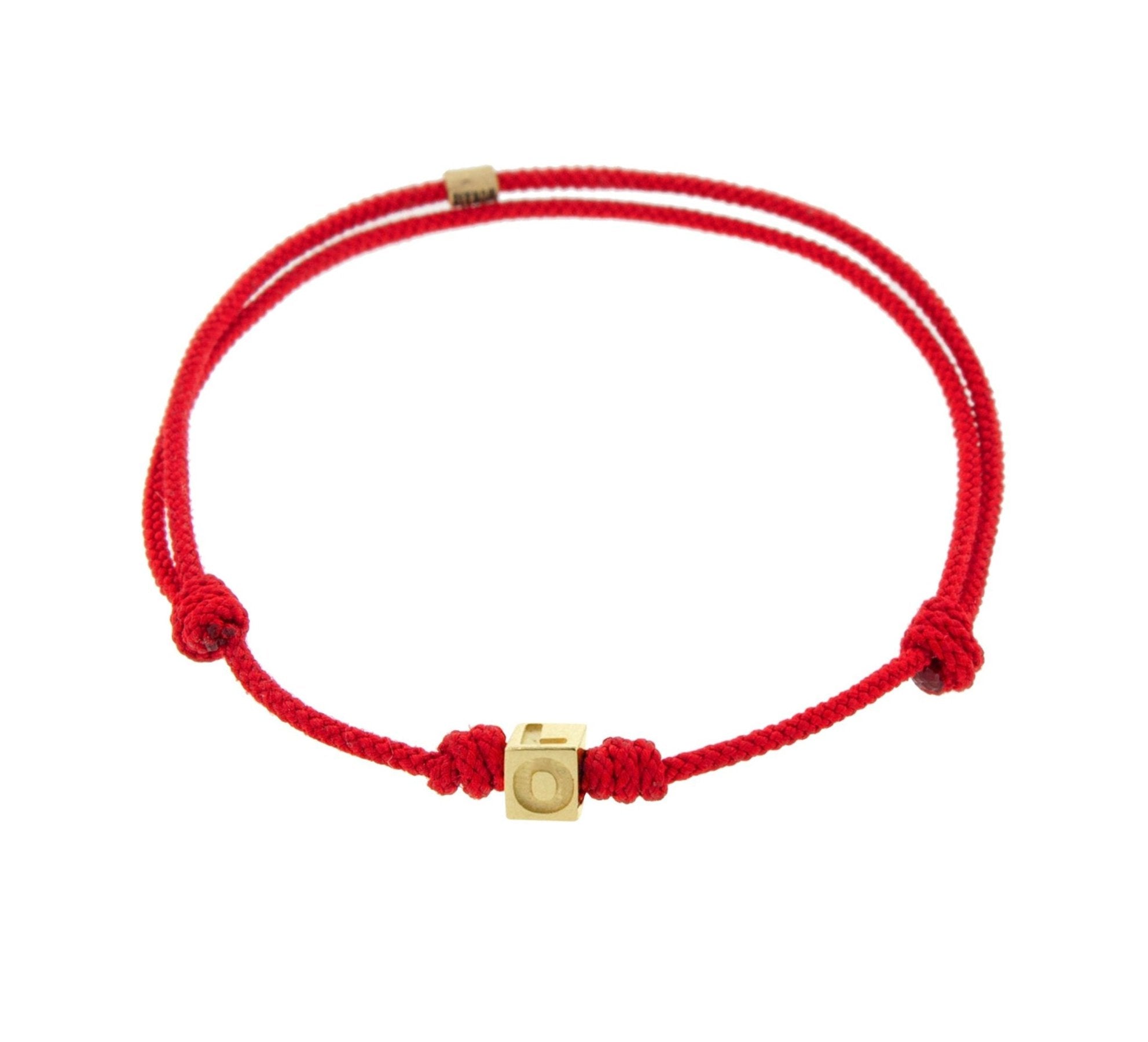 LUIS MORAIS 14k yellow gold cube on an adjustable cord bracelet. Gold logo spacer.
