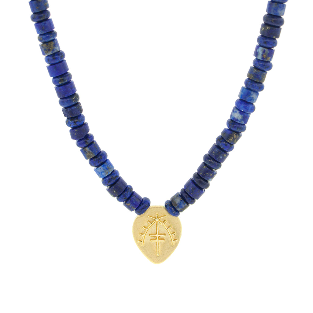 Luis Morais 14K yellow gold shield pendant with an Moor symbol on a lapis gemstone beaded necklace. 14K yellow gold long clasp closure.  The length of this necklace is 18 inches, if you would like a different length, please reach out to customer service. 