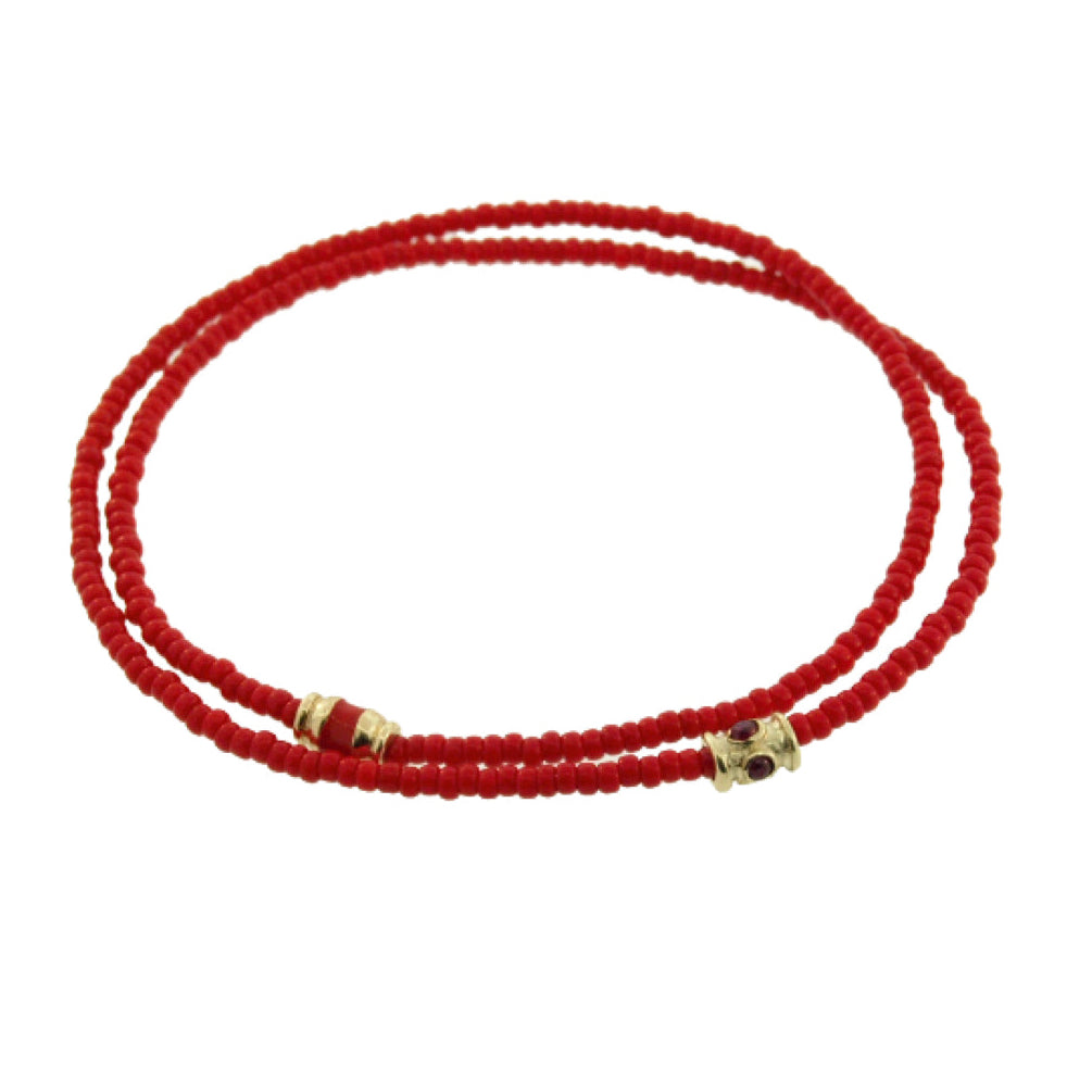 Red beaded necklace with gold and red accents on a white background