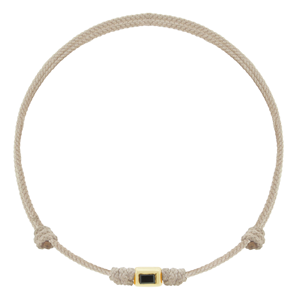 LUIS MORAIS 14k yellow gold small ingot with a baguette black diamond on an adjustable cord bracelet.