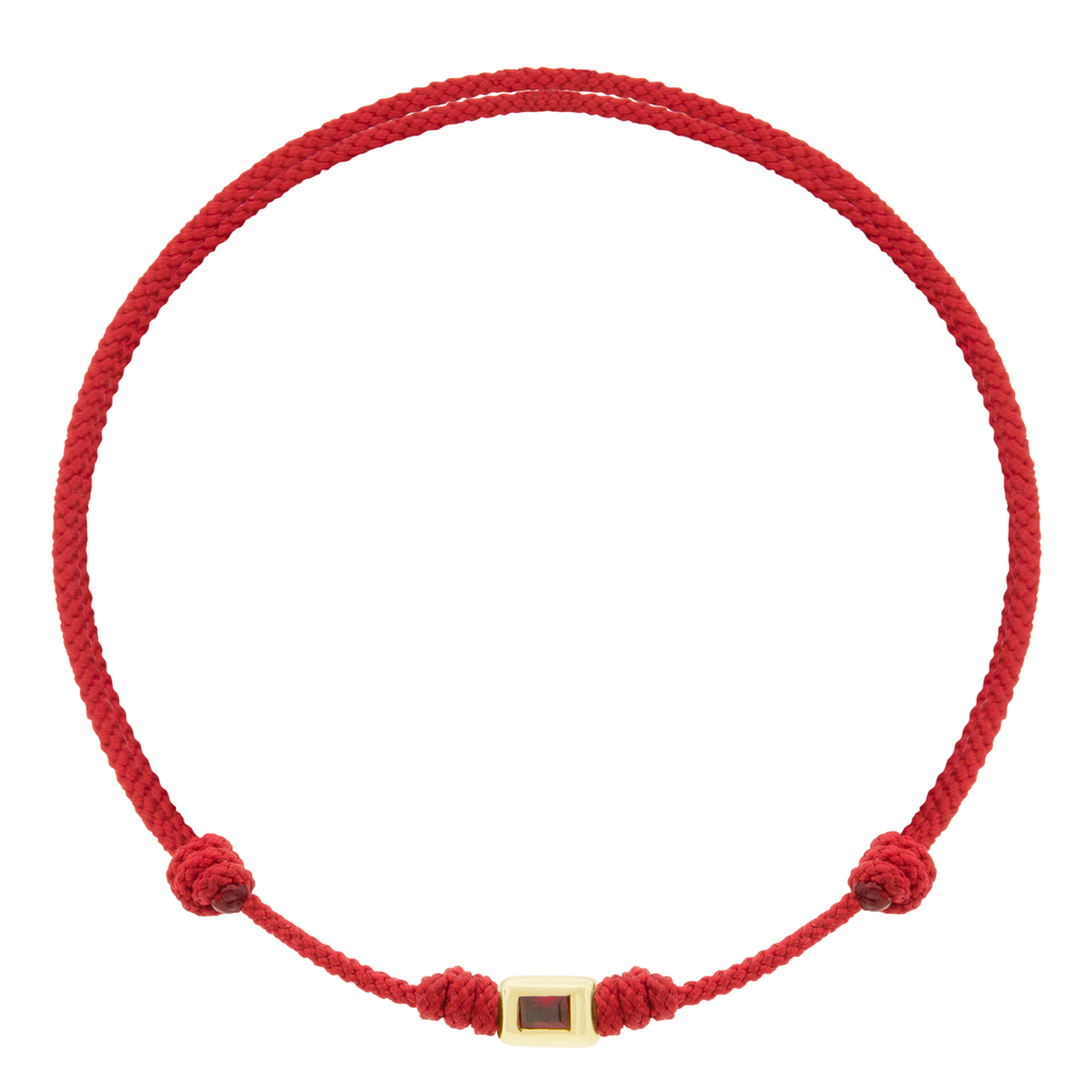 LUIS MORAIS 14k yellow gold small ingot with a Ruby baguette on an adjustable cord bracelet.