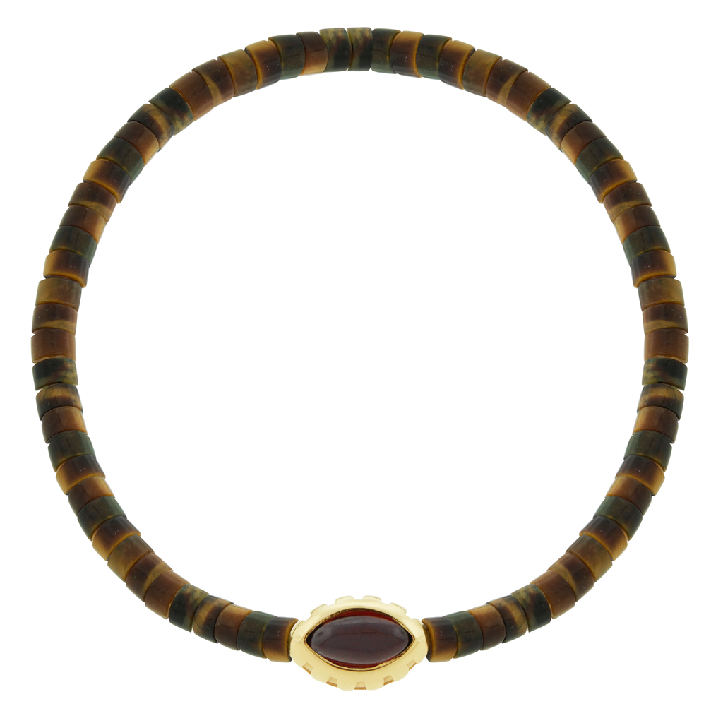LUIS MORAIS 14k yellow gold Eye of the Idol bead with a marquise Garnet gemstone on a <span data-mce-fragment="1">Tiger's Eye</span>&nbsp;beaded bracelet.