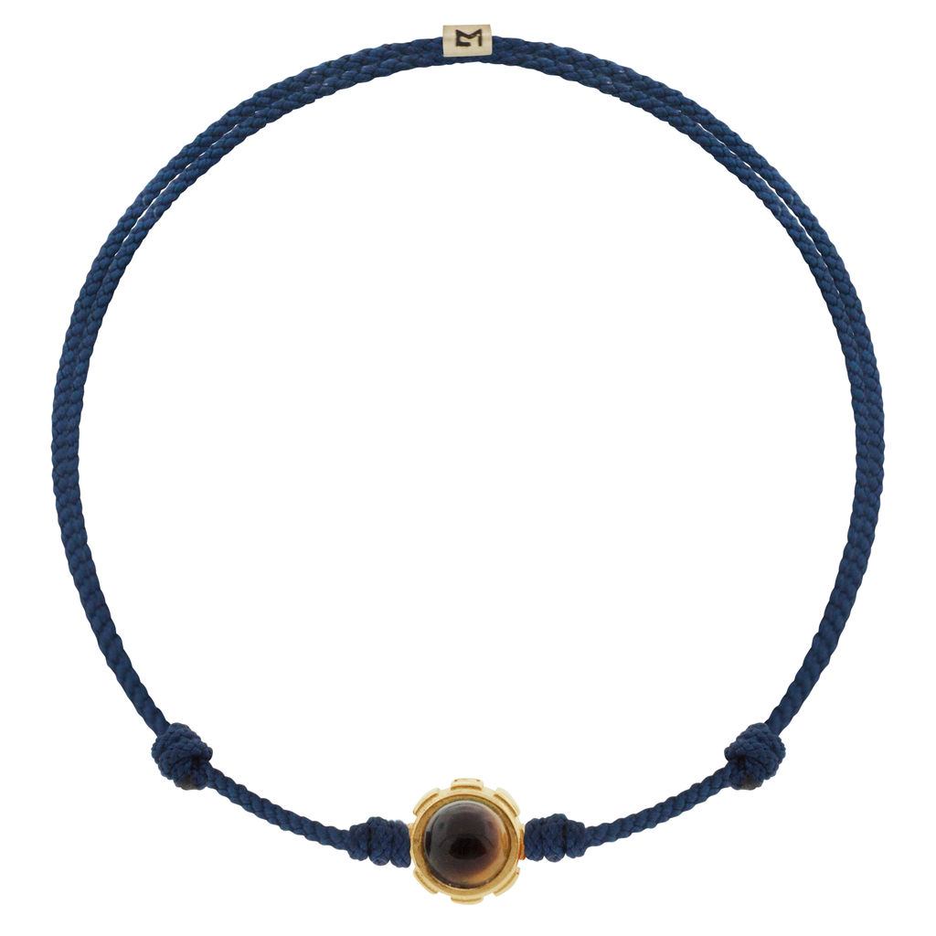 LUIS MORAIS 14k yellow gold rotary collar with Lapis and Tiger's Eye cabochon gemstones on an adjustable cord bracelet. Features a 14k yellow gold logo spacer.  *If you require a size that is not available in the options provided, please indicate your preferred size in the designated text box during checkout.