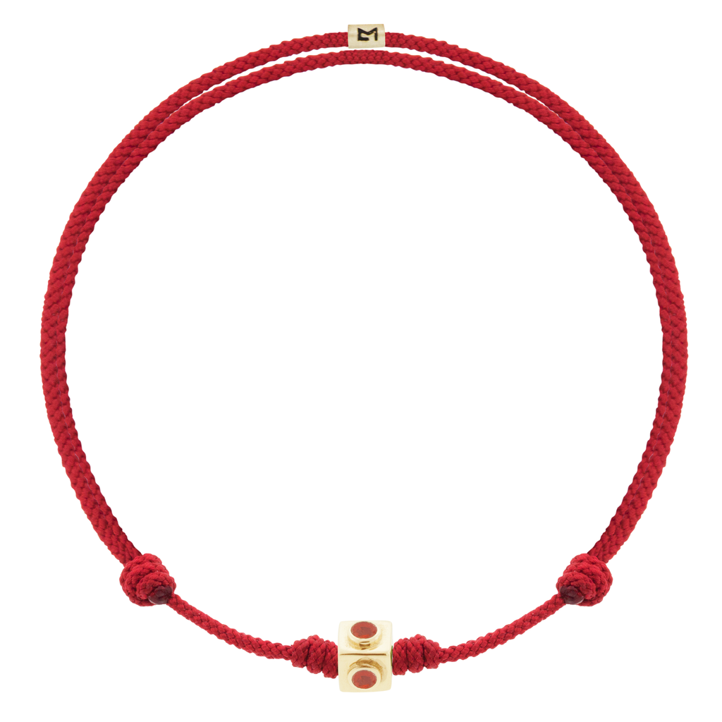 LUIS MORAIS 14k yellow gold small Lego cube (5mm) inlaid with four Coral sides on an adjustable red cord bracelet. Features a 14k yellow gold logo spacer.  *If you require a size that is not available in the options provided, please indicate your preferred size in the designated text box during checkout.