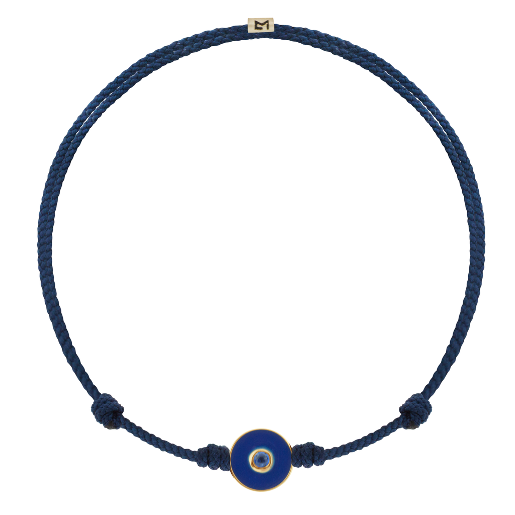 LUIS MORAIS 14k yellow gold small enameled Evil Eye disk with a blue Sapphire gemstone in the center on an adjustable cord bracelet. Features a 14k yellow gold logo spacer.     If you require a size that is not available in the options provided, please indicate your preferred size in the designated text box during checkout.