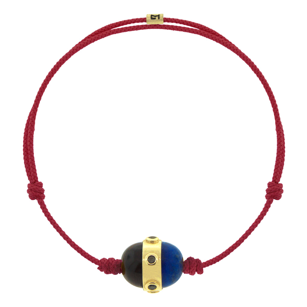 LUIS MORAIS 14K yellow gold vertical collar with round black diamond bezels and two gemstone cabochons on an adjustable cord bracelet. Features a 14K gold logo spacer.