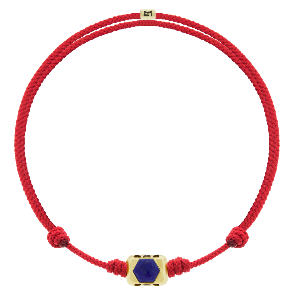 LUIS MORAIS 14k yellow gold ingot with a Lapis hexagon with antiqued words on an adjustable cord bracelet.