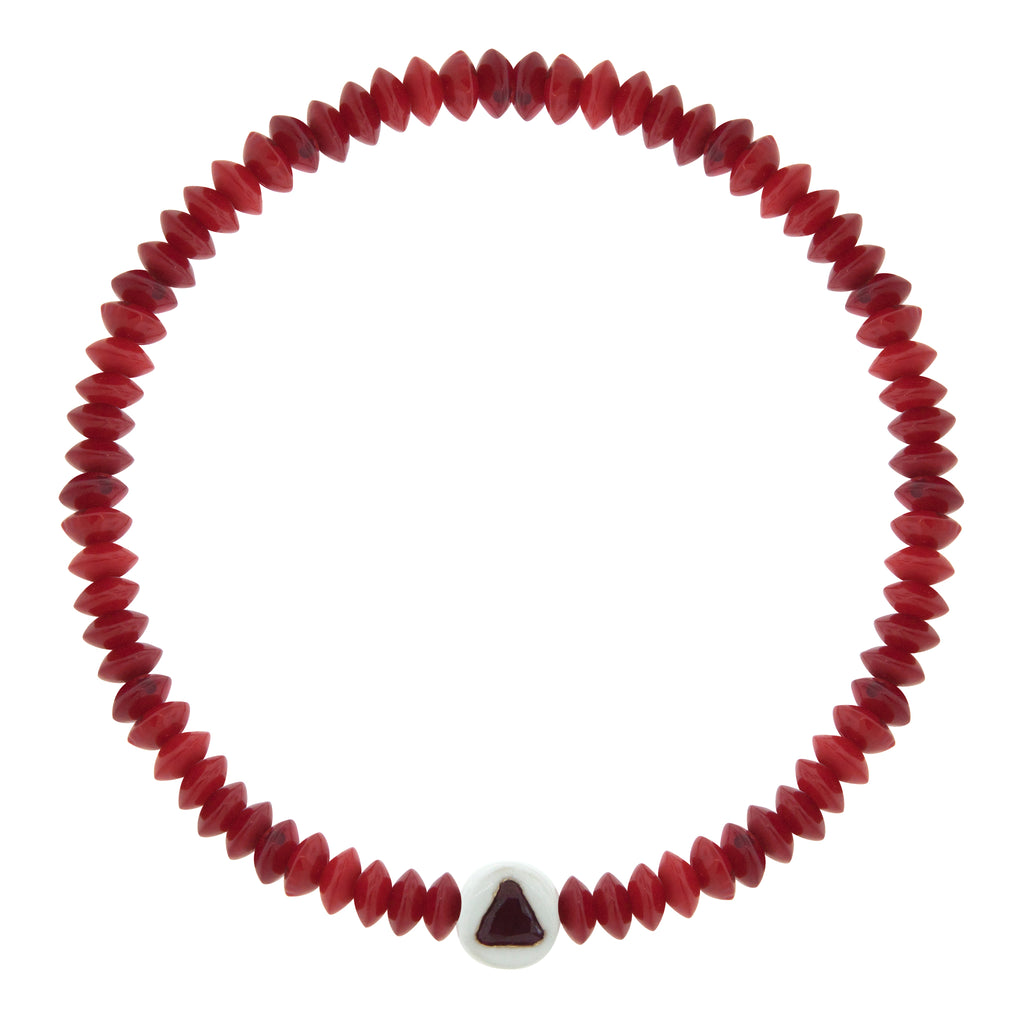 LUIS MORAIS 14K yellow gold enameled large ball with a ruby trillion on a red coral beaded bracelet.