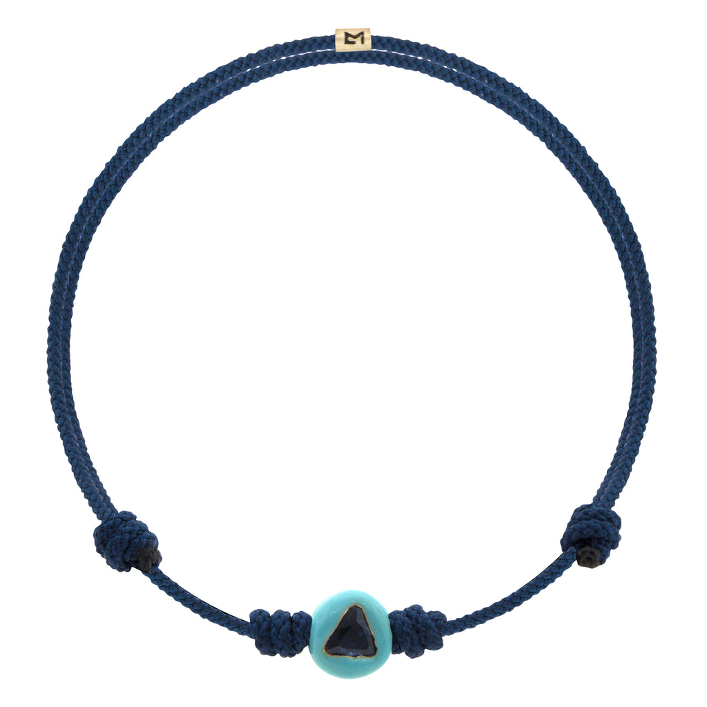 LUIS MORAIS 14K yellow gold enameled large sized ball with a blue sapphire trillion and logo spacer on an adjustable cord bracelet.