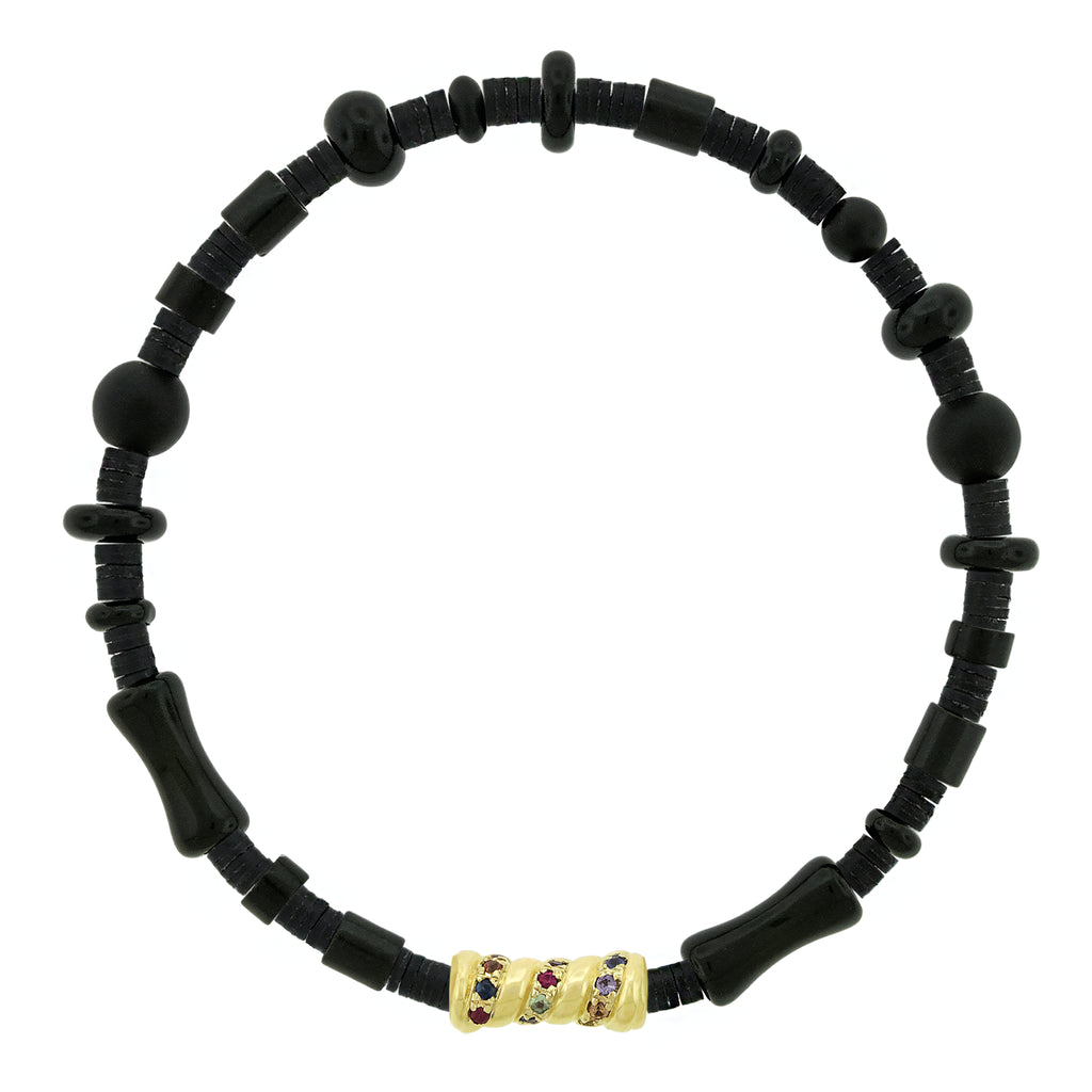 Black beaded bracelet with a gold clasp featuring red and purple stones on a white background