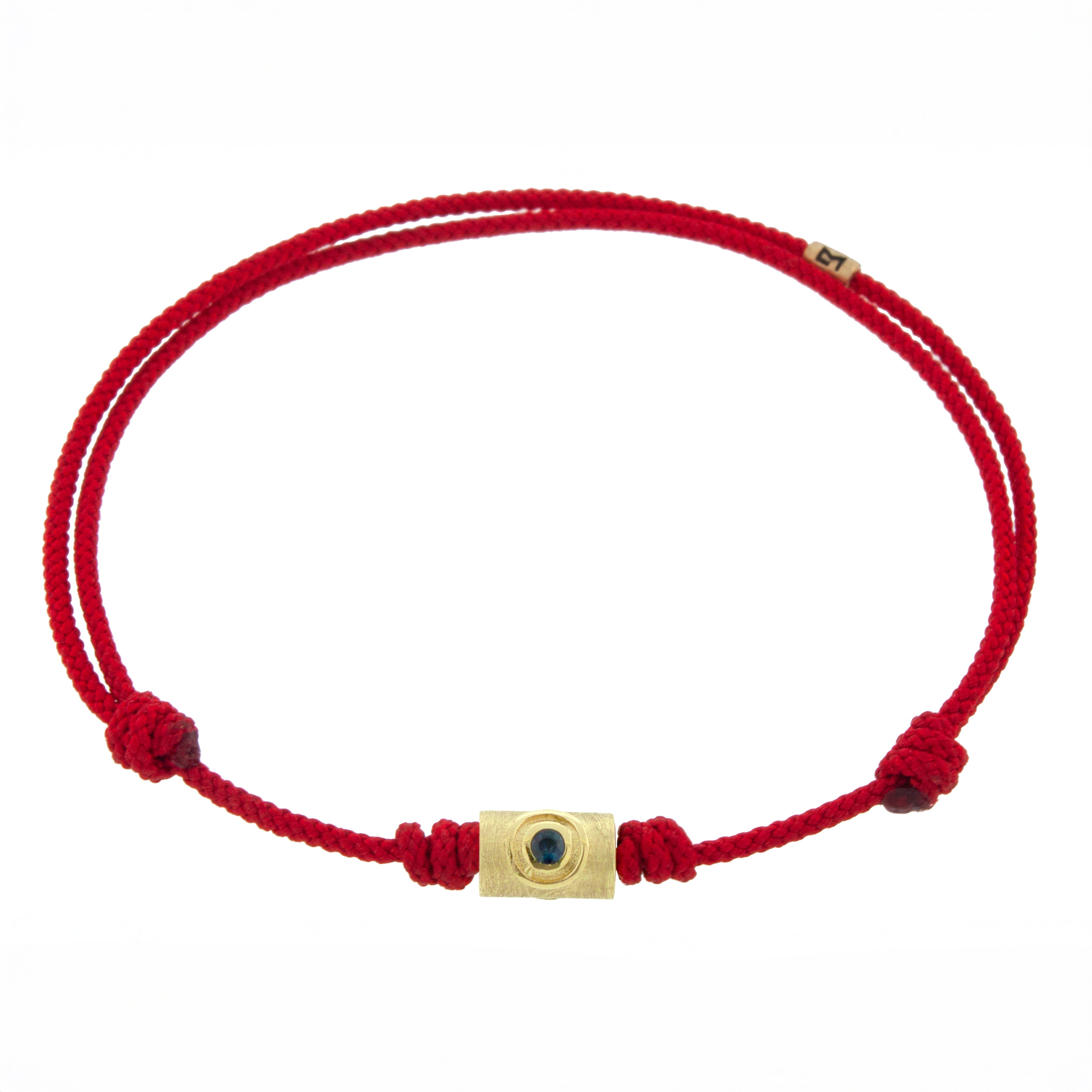 Red cord bracelet with a gold clasp on a white background