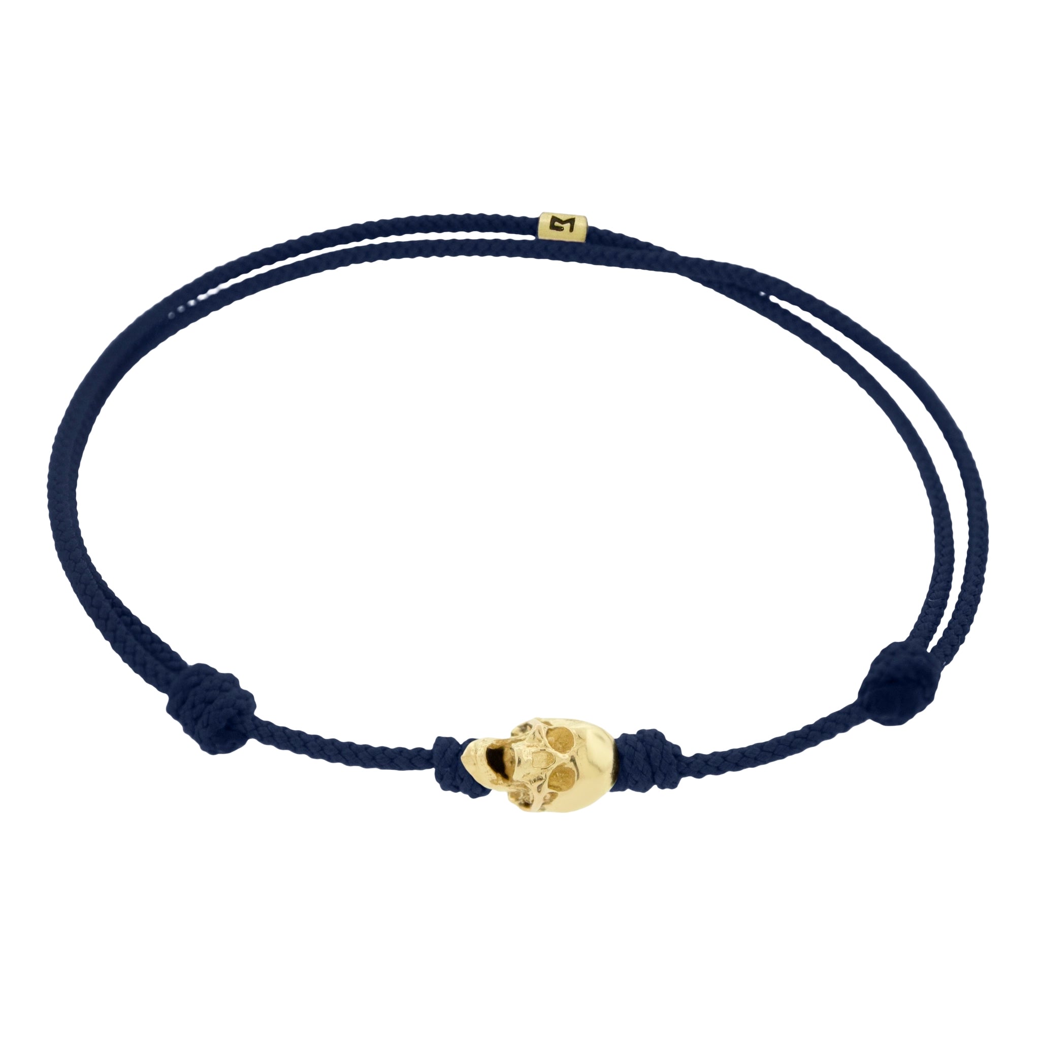 LUIS MORAIS 14k yellow G6 gold skull with moving jaw on an adjustable cord bracelet.