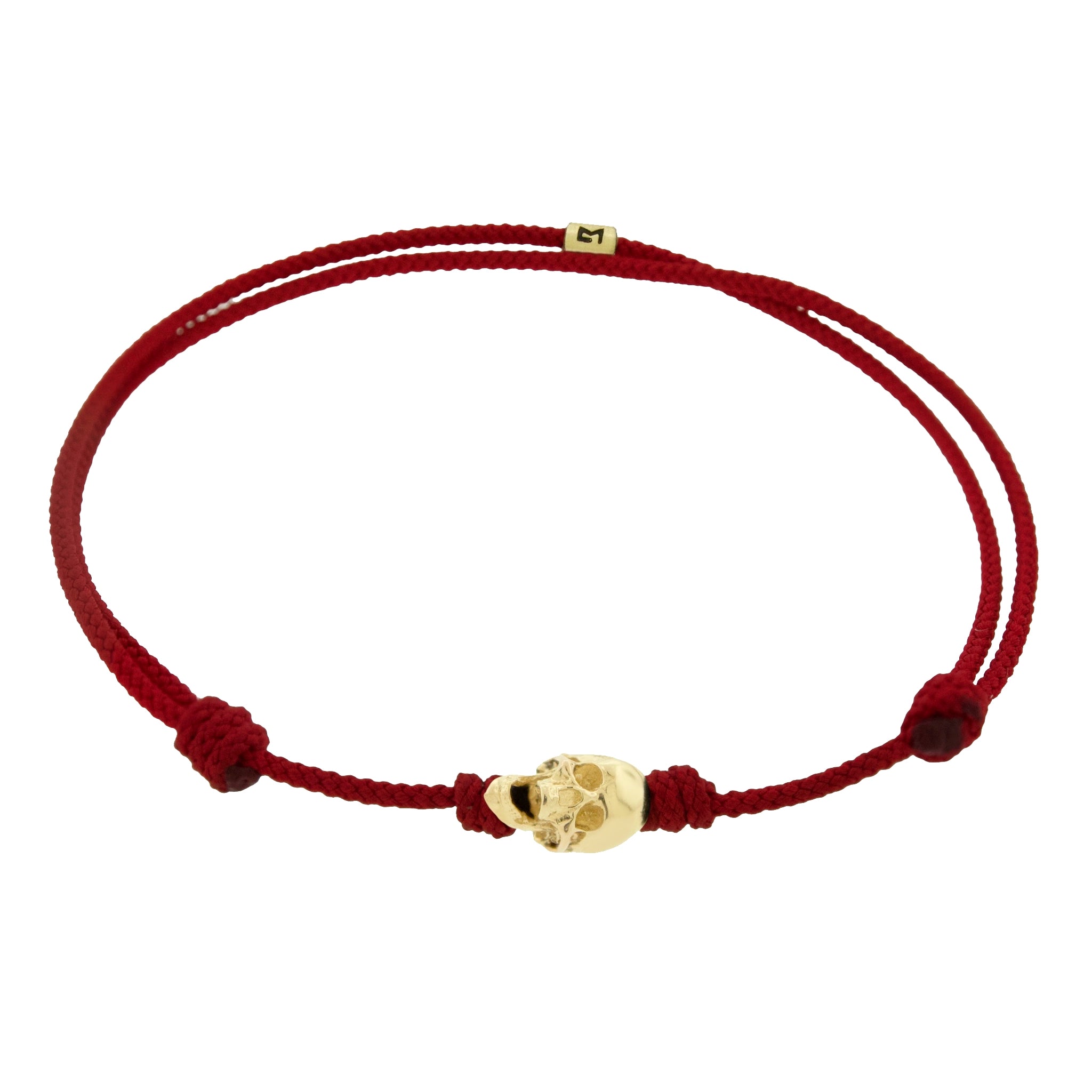 LUIS MORAIS 14k yellow G6 gold skull with moving jaw on an adjustable cord bracelet.