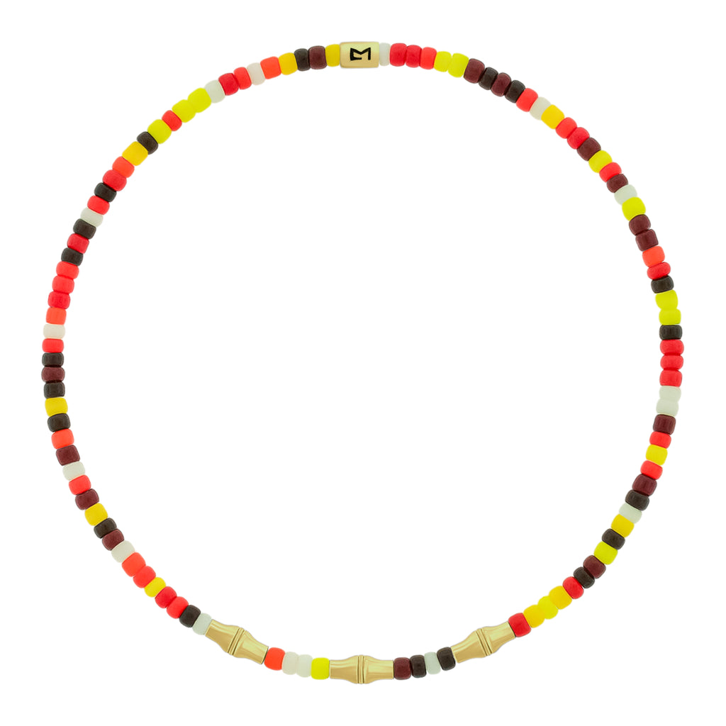 LUIS MORAIS glass beaded bracelet with three 14k yellow gold mini Canister Bamboo tubes and gold logo spacer.&nbsp;Bamboo symbolizes strength, resilience, and the ability to grow through adversity.

