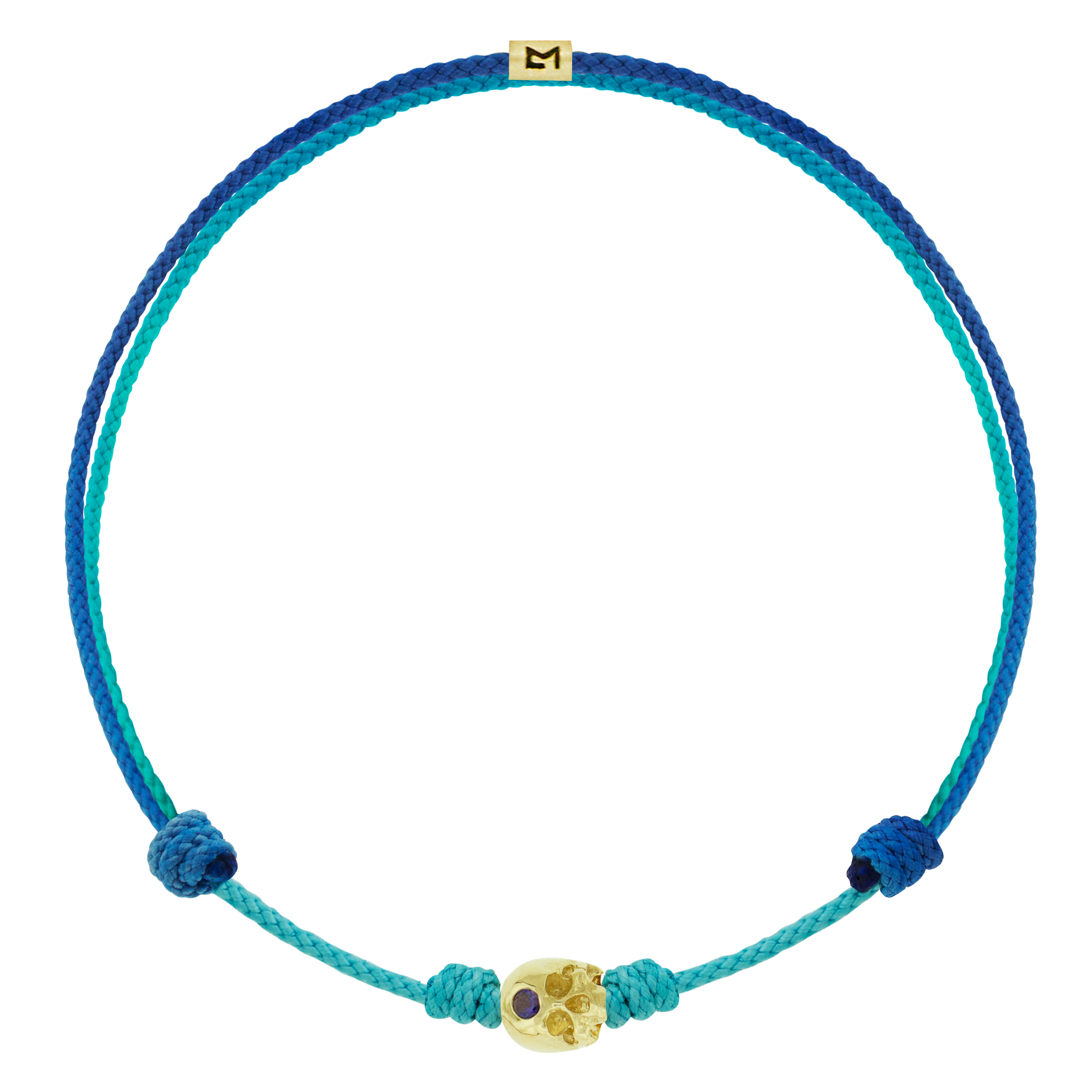 LUIS MORAIS 14k yellow gold half-skull with a blue sapphire on an adjustable cord bracelet. The skull is adorned with a stone on the forehead, representing the Third Eye Chakra, which symbolizes intuition and spiritual insight.