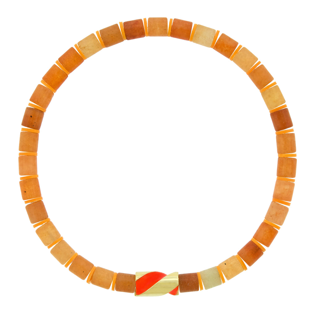 LUIS MORAIS 14k yellow gold enameled short drill bit on a gemstone beaded bracelet. The drill bit design is symbolic of digging deeper into oneself and life’s challenges. It represents resilience and the pursuit of discovery, encouraging the wearer to push through obstacles and uncover hidden truths.