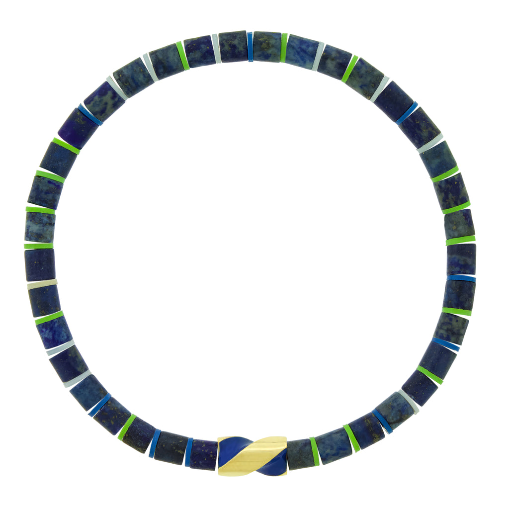 LUIS MORAIS 14k yellow gold enameled short drill bit on a gemstone beaded bracelet. The drill bit design is symbolic of digging deeper into oneself and life’s challenges. It represents resilience and the pursuit of discovery, encouraging the wearer to push through obstacles and uncover hidden truths.