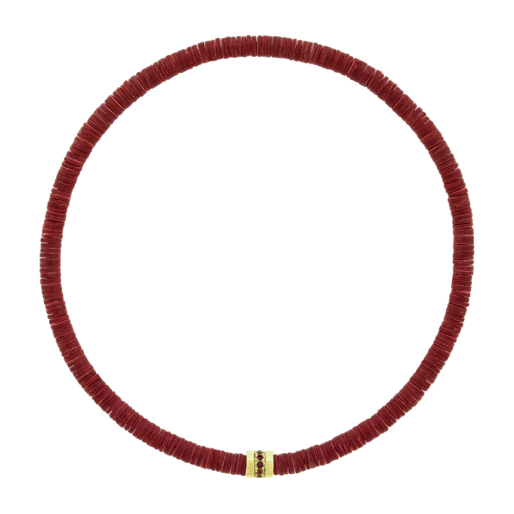LUIS MORAIS 14K yellow gold short roll with a line of round rubies on a vinyl beaded bracelet. A versatile piece that pairs easily with other styles and is ideal for adding to your stack.