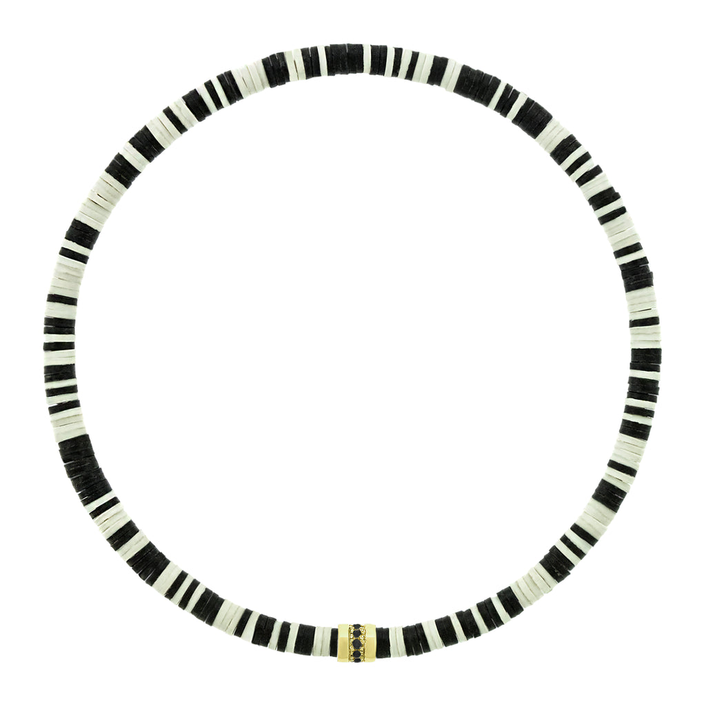 LUIS MORAIS 14K yellow gold short roll with a line of round black diamonds on a vinyl beaded bracelet. A versatile piece that pairs easily with other styles and is ideal for adding to your stack.