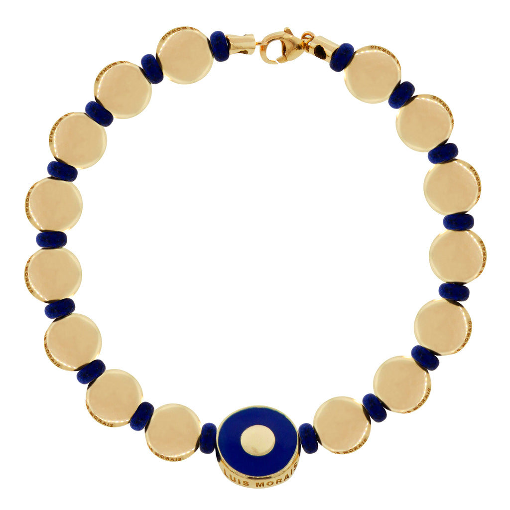 LUIS MORAIS 14k yellow gold enameled eye disk with many small plain disks and a 14k yellow gold lobster clasp on a bracelet.