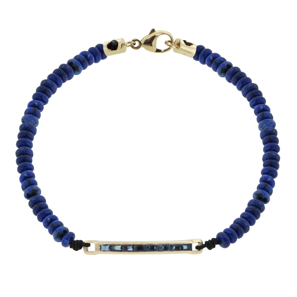 LUIS MORAIS 14K gold medium link ID bar with blue sapphire baguettes on a lapis gemstone beaded bracelet with 14k yellow gold lobster clasp closure.