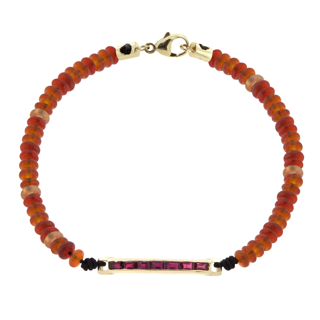 LUIS MORAIS 14K gold medium link ID bar with ruby baguettes on a carnelian gemstone beaded bracelet with 14k yellow gold lobster clasp closure.