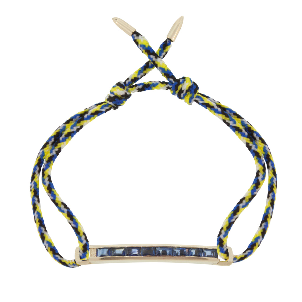 LUIS MORAIS 14K gold medium link bar with blue sapphire baguettes and bullet tip ends on an adjustable cord bracelet.    *If you require a size that is not available in the options provided, please indicate your preferred size in the designated text box during checkout.