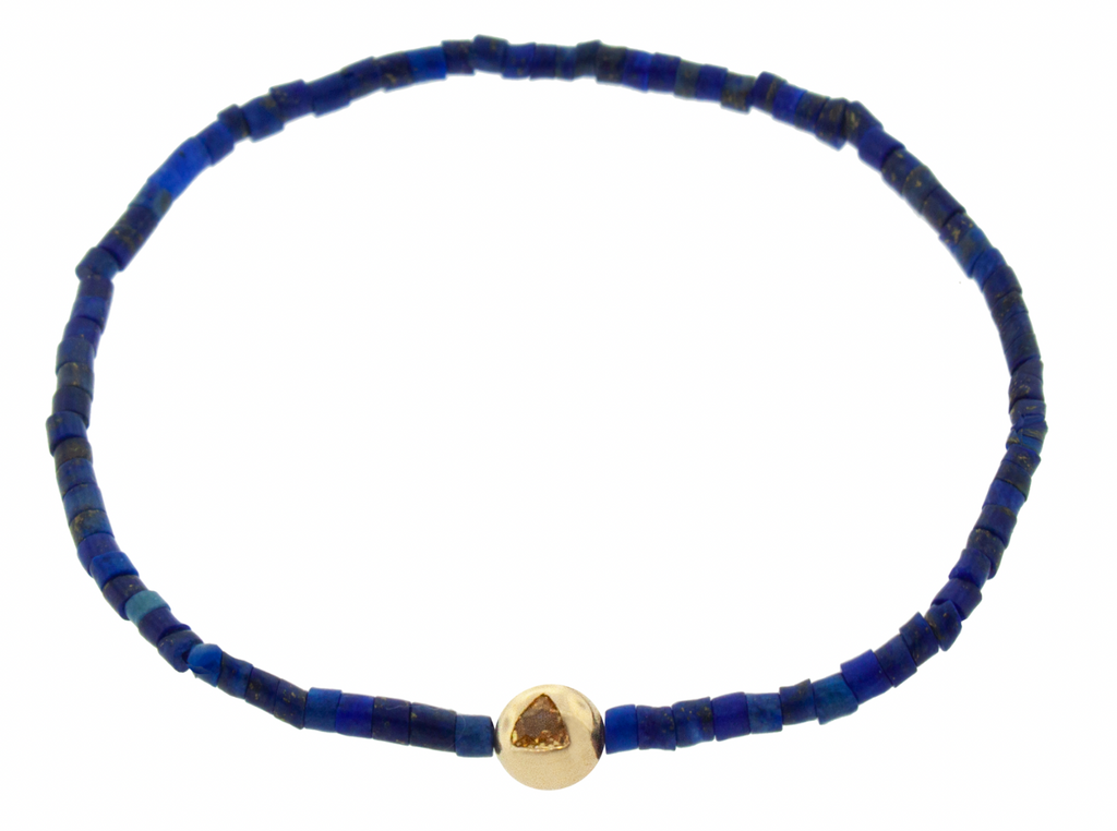 LUIS MORAIS 14K yellow gold medium ball with a orange sapphire trillion on a Lapis gemstone tube beaded bracelet.