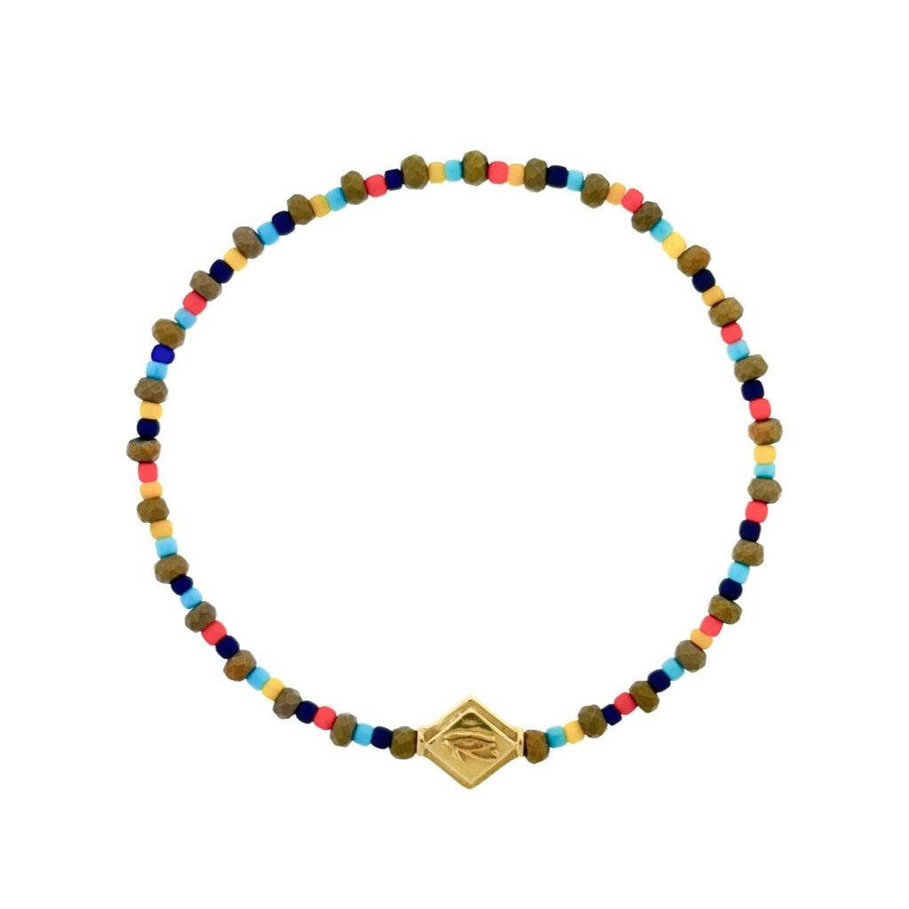 LUIS MORAIS 14k yellow gold lozenge with Horus Eye symbol on a beaded bracelet.