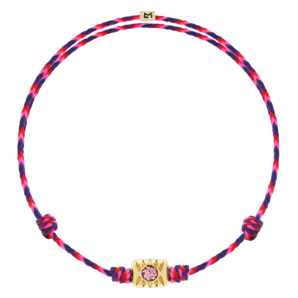 LUIS MORAIS 14k yellow gold eye ingot with a round pink Sapphire center on an adjustable cord bracelet.