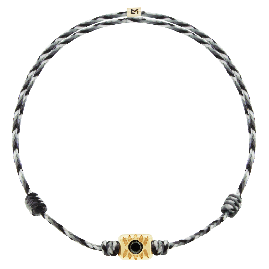 <p>LUIS MORAIS 14k yellow gold Eye Ingot with a round black Diamond center on an adjustable cord bracelet.</p> <ul> <li></li> </ul>