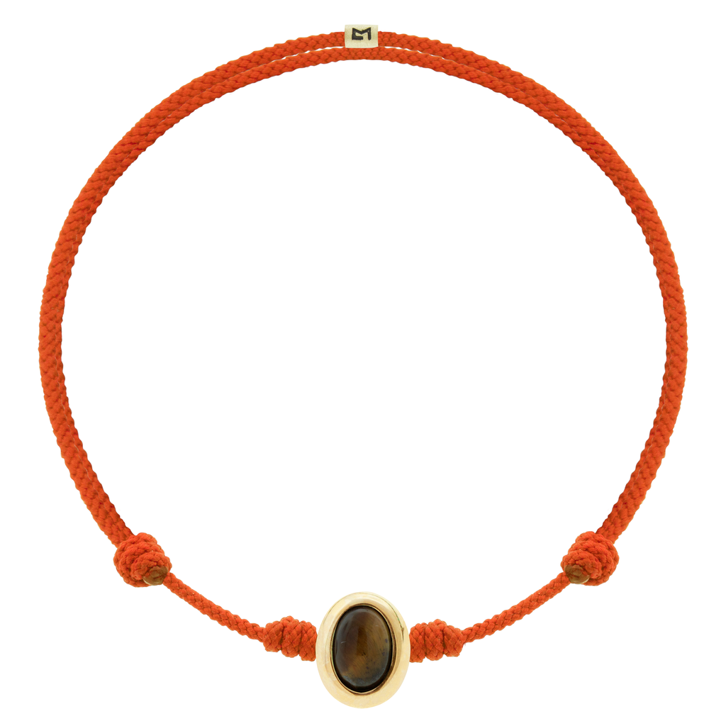 LUIS MORAIS 14k yellow oval cabochon <em>Eye of the Idol</em> bead with a Tiger's Eye gemstone center on an adjustable cord bracelet.