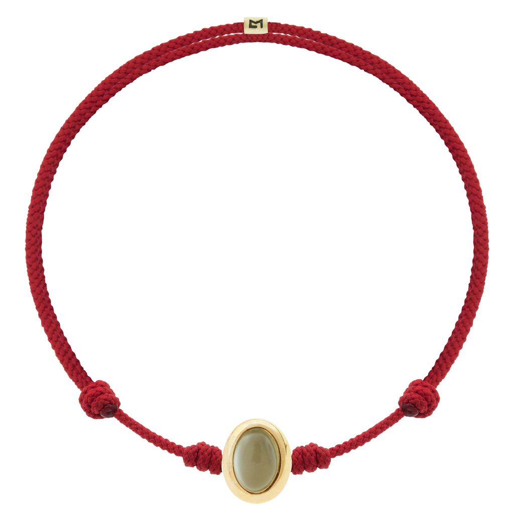 LUIS MORAIS 14k yellow oval cabochon <em>Eye of the Idol</em> bead with a Moonstone gemstone center on an adjustable cord bracelet.