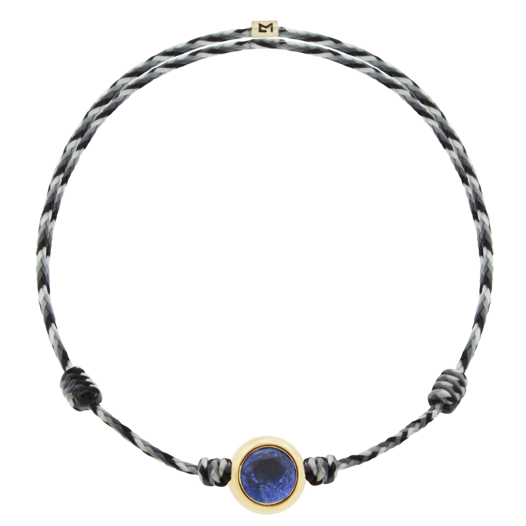 LUIS MORAIS 14k yellow round <em>Eye of the Idol</em> bead with a Blue Sapphire gemstone center on an adjustable cord bracelet.