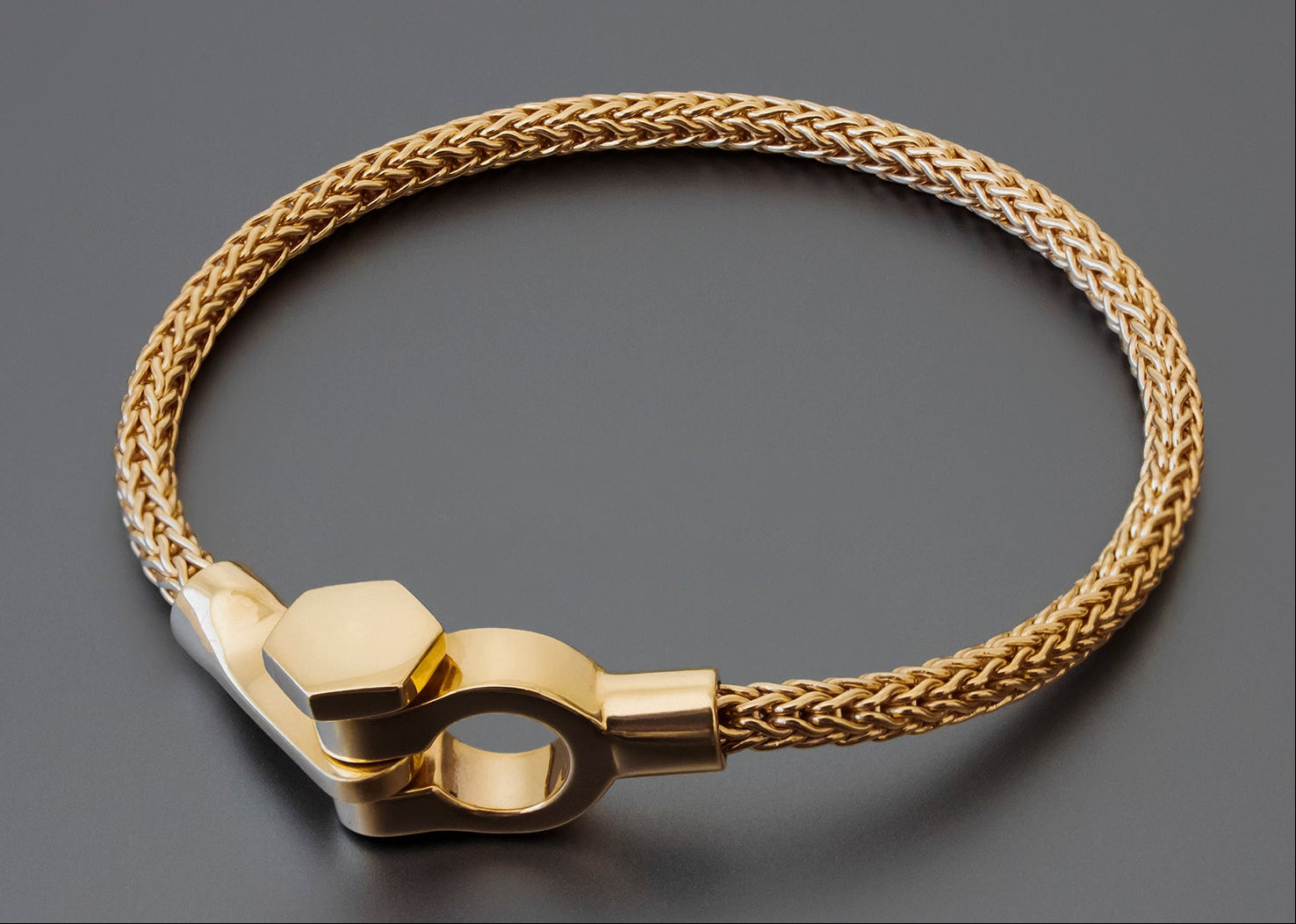 Gold bracelet on a dark gray background