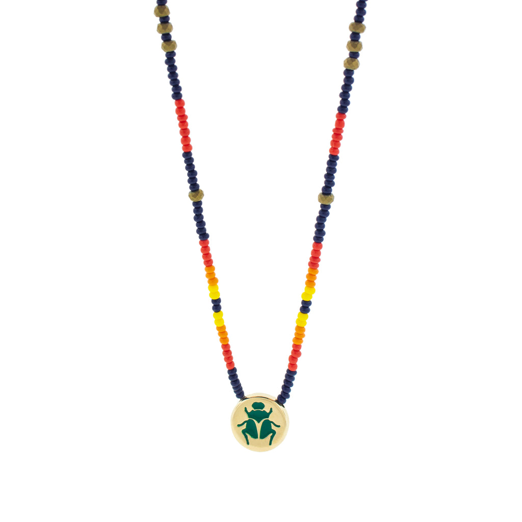 LUIS MORAIS 14k yellow gold large disk with green enameled Scarab symbol on a 27 inch tribal pattern beaded necklace. Features gold logo spacer.