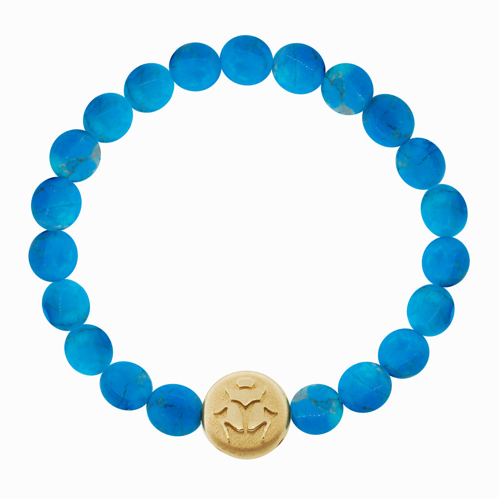LUIS MORAIS 14K yellow gold large disk with a scarab symbol on medium turquoise disks on a beaded bracelet. The symbol is on both sides of the gold.