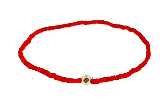 Boule d'or avec diamant blanc sur bracelet de perles de verre