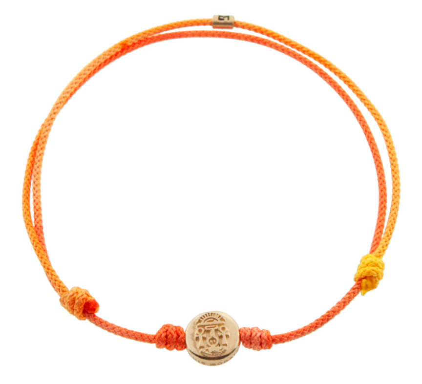LUIS MORAIS 14K yellow gold small disk with a good luck symbol on a yellow ombre cord bracelet. The symbol is on both sides of the gold.