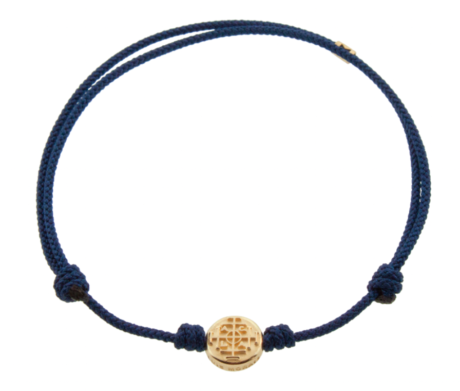 LUIS MORAIS 14K yellow gold small disk with a money seal symbol on a navy cord bracelet. The money seal is meant to bring good fortune to the wearer. The symbol is on both sides of the gold.